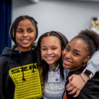 Girls of Color Summit previous event three girls smiling and holding each other